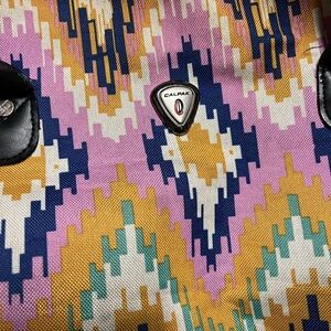 Calpak Vibrant Pattern durable rolling duffle carry-on luggage, long handle.